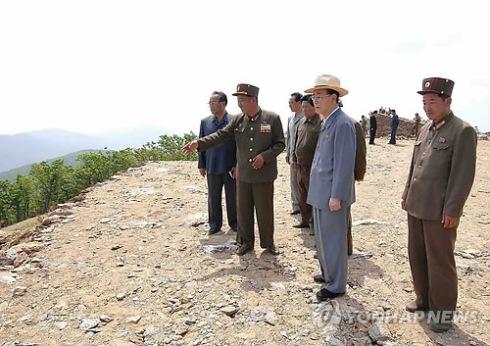DPRK head of state Kim Yong Nam (2nd R) is briefed about the construction of a ski slope at the construction of Masik Pass Ski Park on 9 June 2013