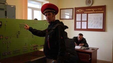Hayden wearing an official hat in a railway control room  