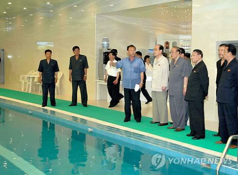 DPRK nominal head of state Kim Yong Nam and other senior DPRK officials view an employees' swimming pool at Pyongyang Essential Foodstuffs Factory (Photo: KCNA-Yonhap).