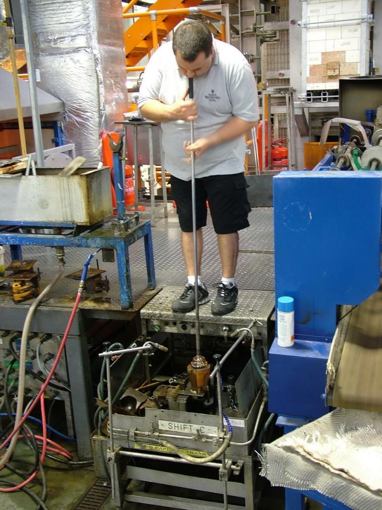 Our tour of the House of Waterford Crystal in Ireland glass blower blows into molten glass vase - house of waterford crystal - waterford - ireland