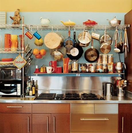 pots and pans hanging over stovetop open storage kitchen stove