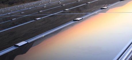 Solar PV Prices in the U.S. Continue to Fall Rapidly A view of the sunset reflecting in a solar panel. (Credit: Flickr @ Thomas Galvez http://www.flickr.com/photos/togawanderings/)