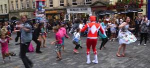 At the Edinburgh Fringe, Jimmy Savile show actor beaten up in the street after being named in Chortle website review Juliette Burton (right) and her flash mob yesterday in the High Street