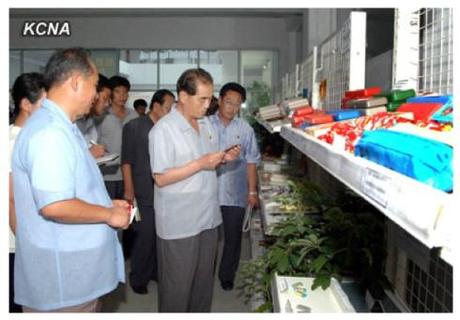 DPRK Premier Pak Pong Ju inspects consumer goods at an exhibition organized by the Academy of Agricultural Sciences (Photo: KCNA).