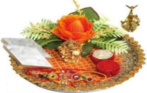 A typical Rakhi thali has the Rakhi, kumkum(red powder), arti (camphor lit to take away evil eye), akshthalu (rice used to bless) Indian sweets and may be an Idol of God