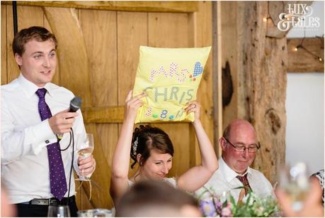 bride holds up handmade pillow at her barn wedding at Old Green Barn 