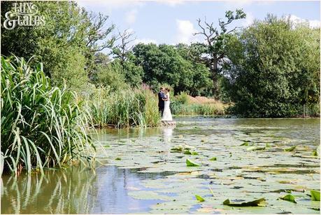 Bride and froom in front of lillypads on lake at old green ban wedding venue