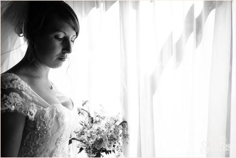 Bride looks at flowes UK wedding photograph