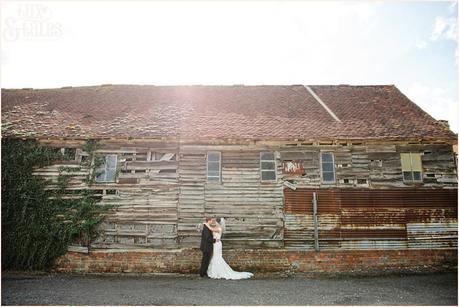 Relaxed wedding pose in front of barn