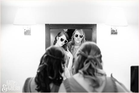 bridemaids wearing heart shaped sunglasses making duck pace in mirror 