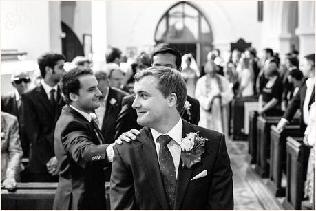 best main comforts groom during the ceremony in UK church wedding reportage style photography