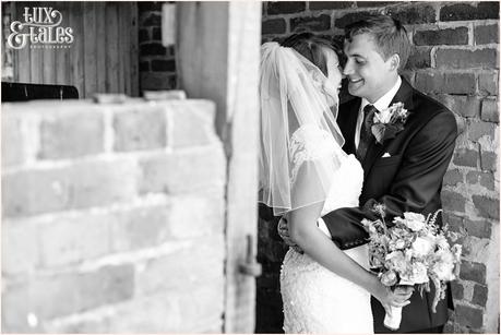 Quirky wedding photography at old green barn of bride holding wild flowers