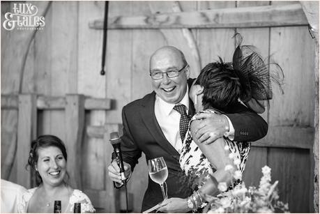 Father of the bride laughs and hugs at UK barn wedding 