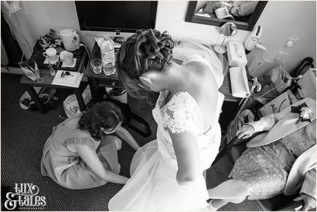 Bride getting into wedding dress photographed from birds eey view angle