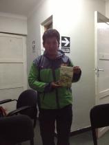 Amazing Alpaca guide Efrain receiving a copy of Turn Right at Machu Picchu as a gift from a happy client.