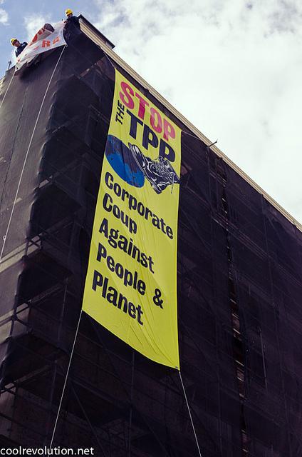 Activists Banner Drop and Lock Down at US Trade Rep Building to Expose TPP Negotiations StopTPP1