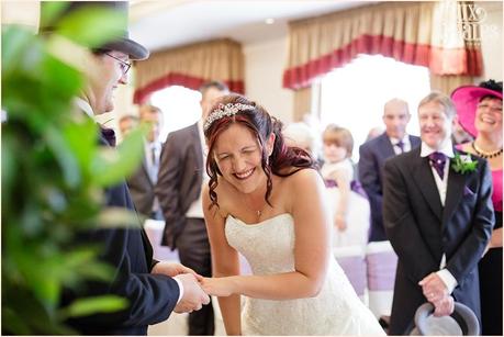 Bride laughs during the exchange of the rings at Woburn Abbey Wedding 
