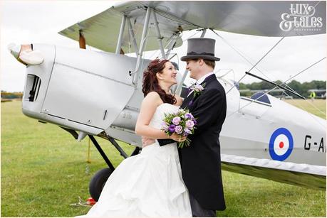 Bride & Groom pose in front of a vintage tiger moth aeroplane at Woburn Abbey Airshow