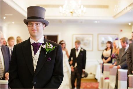 Groom in top hat at front of the aisle, whilst bdie walks up the aisle