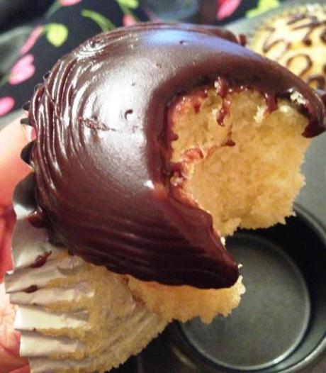 biting into cupcake with thick chocolate fudge icing ready made from silver spoon