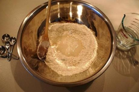 Put flour in bowl, make a well for water Olive and parmesan bread rolls