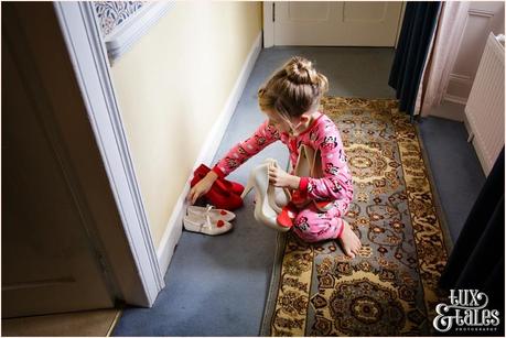Julia & Chris Got Married! | Wedding Photography Little girl arranged Melissa red heart wedding shoes at Yorkshire Wedding