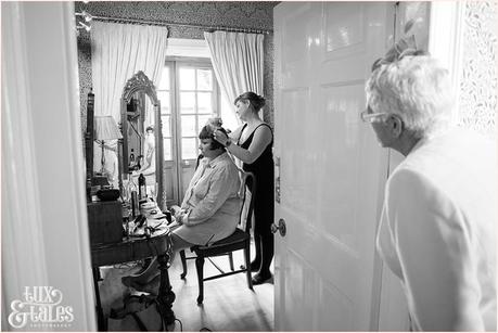 Julia & Chris Got Married! | Wedding Photography Brides mother looks on has bride has hairpiece put on at vintage wedding in yorkshire