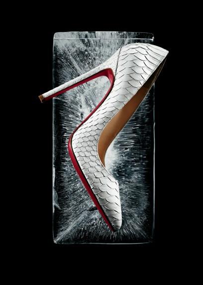 Christian Louboutin  “Pigalle” point-toe pumps in white python. $1,345