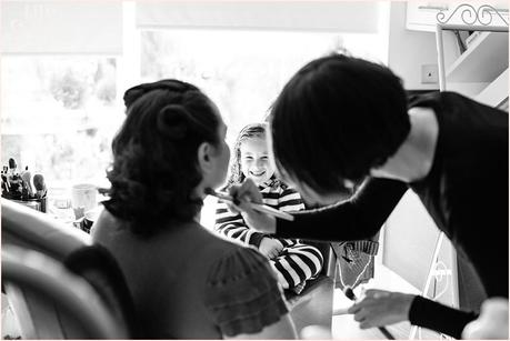 Yorkshire Wedding Photography | Katie & Gavin Got Married! Flower girl watches as bride has makeup applied by Vicky Farr