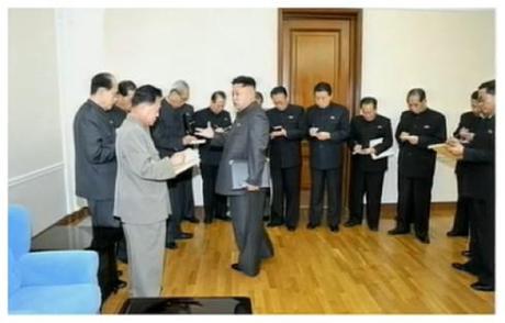 Kim Jong Un talks to senior KWP and DPRK Government officials after an 8 December 2012 expanded meeting of the KWP Political Bureau (Photo: KCTV screen grab).