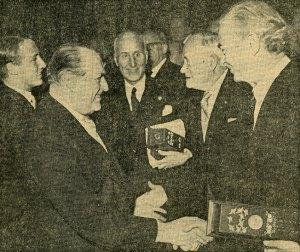Pauling, holding the case containing his Nobel diploma, being congratulated by Norwegian King Olav V. Image originally published in Morgenbladet, December 11, 1963.