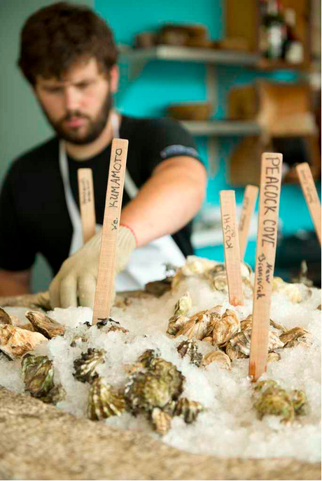 Here’s a fellow working at the Eventide Oyster Company of Portland, ME, who is clearly too occupied with the oysters right now to curate a compilation of the year’s best year-end lists. That means it’s all up to me.