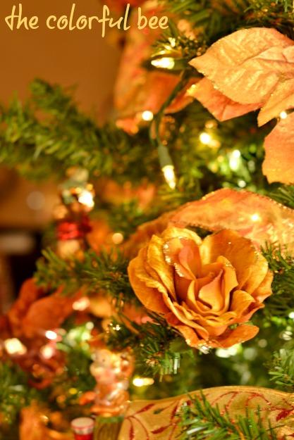 Putting Christmas Away florals and faux poinsettias in Christmas tree