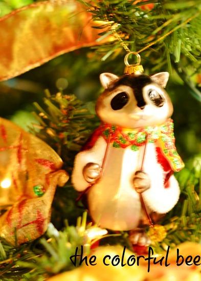 Putting Christmas Away Racoon ornament in Christmas tree
