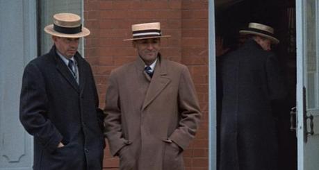 Truth vs. Fiction: The Bank-Robbing Style of Warren Oates as Dillinger Dillinger and Van Meter prep for a bloody day in East Chicago. On the right, Dillinger furtively stands in the bank entrance where his only victim in the film will soon be standing.