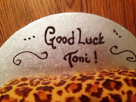 hand piped in dark chocolate message on cake good luck toni