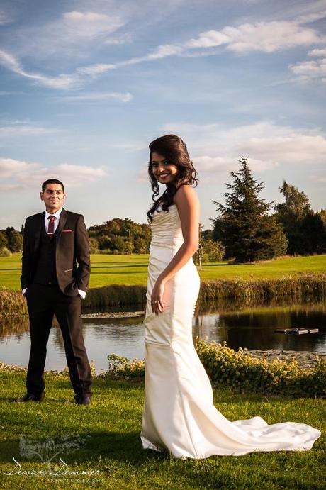 Bride and groom on the green at Woolston Manor