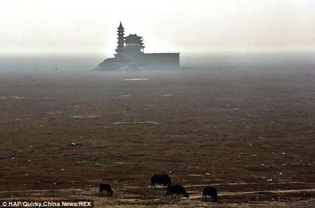 Dry land: The pavilion and tower in the distance used to be based in the center of China's largest lake which has dried up because of drought