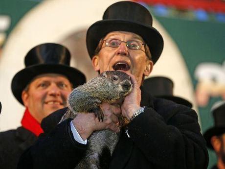Punxsutawney Phil is held by Ron Ploucha after emerging from his burrow Sunday on Gobblers Knob in Punxsutawney, Pa., to see his shadow and forecast six more weeks of winter weather. (Photo: Gene J. Puskar, AP)