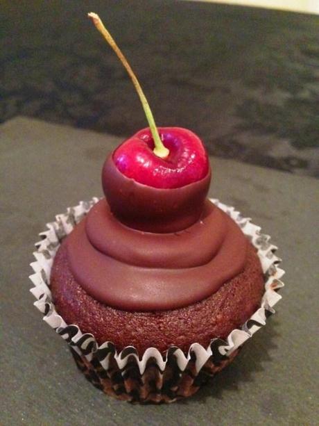 black forest chocolate and cherry flavoured cupcakes with dark chocolate icing and fresh fruit