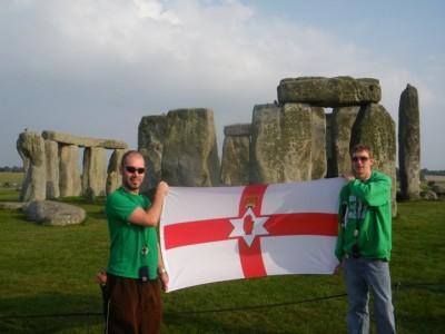 My Top 5 Backpacking Spots Not to Miss in England Myself and my good mate Richard flying the Northern Ireland flag at Stonehenge - one of my favorite backpacking spots in England.