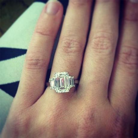 Three stone emerald cut engagement ring with trapezoids