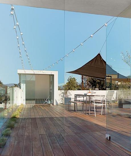 A Minimalist Duplex in Venice, California roof deck with Mangaris plank wood flooring and Kookaburra Shade Sail