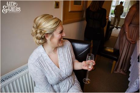 bride laughs as she gets ready at yorkshire wedding