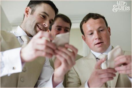 The guys examine their ties at a yorkshire wedding