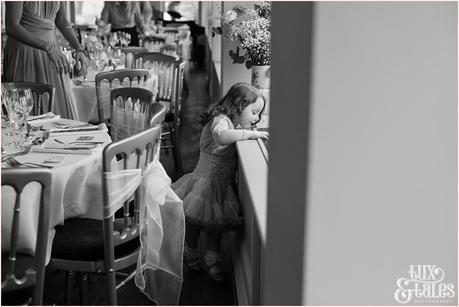 Little girl looks out the window at wedding at the Alma Inn