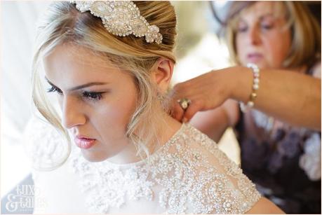mother of the bride helps the bride get ready at yorkshire wedding