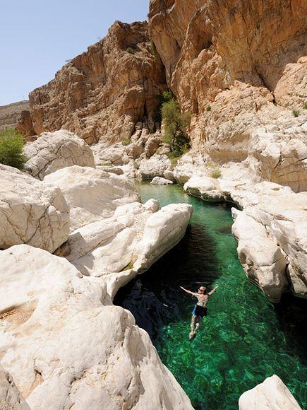 Photo: Man jumping into water in Oman