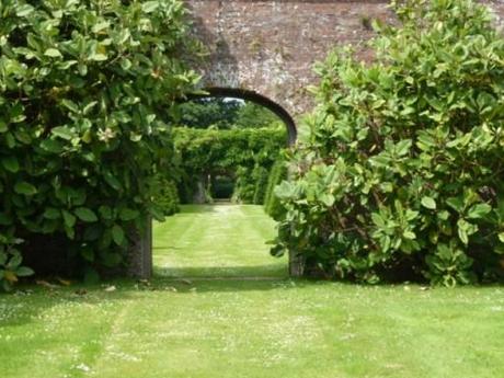 mature shrubs aside garden archway at Petworth