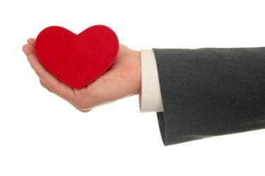 business person holding a heart